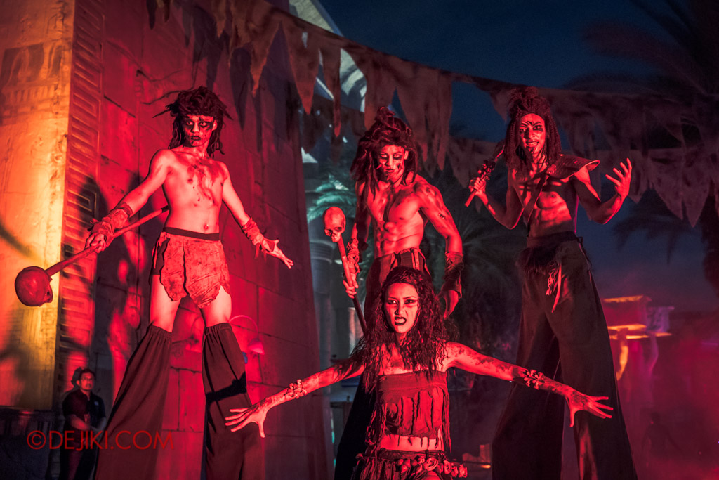 USS Singapore Halloween Horror Nights 8 Cannibal scare zone group stilt walkers with belly dancer