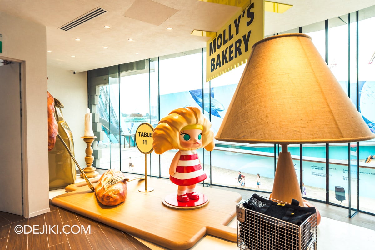 POP BAKERY Singapore at Resorts World Sentosa - Cafe Design Molly Bakery Display MOLLY'S BAKERY display at the top of the stairs, with a MOLLY sculpture wearing croissant hair