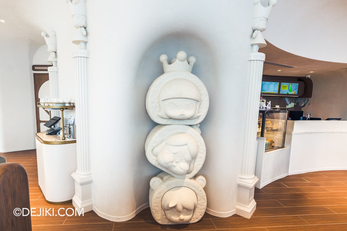 POP BAKERY Singapore at Resorts World Sentosa - Cafe Design POP MART Character Heads in White Alcove POP MART character heads set into a white alcove in the POP BAKERY dining room