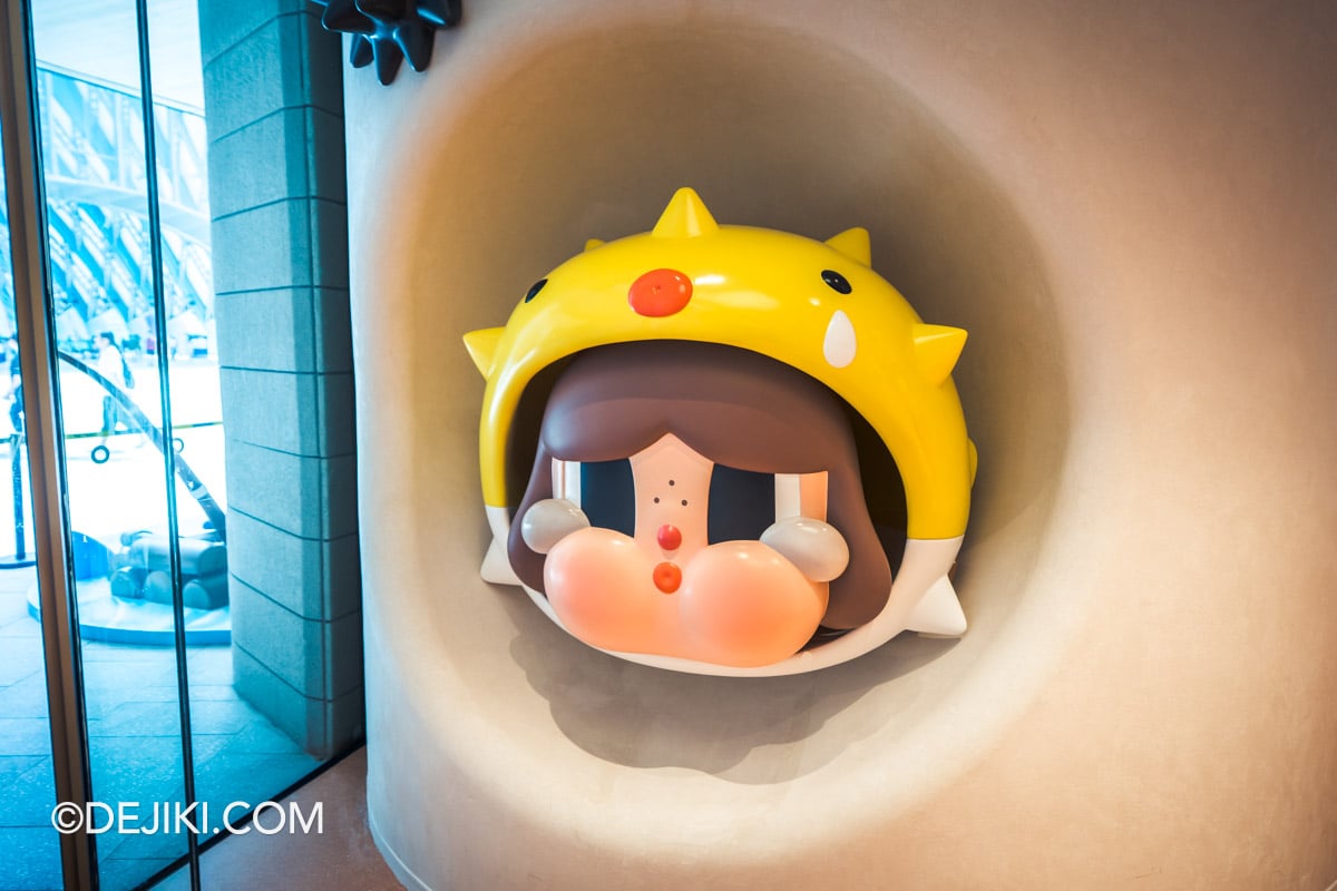 POP MART Resorts World Sentosa - 19 crybaby CRY ME AN OCEAN The PUFFERFISH sculpture CRYBABY CRY ME AN OCEAN pufferfish sculpture set into an alcove at POP MART Resorts World Sentosa