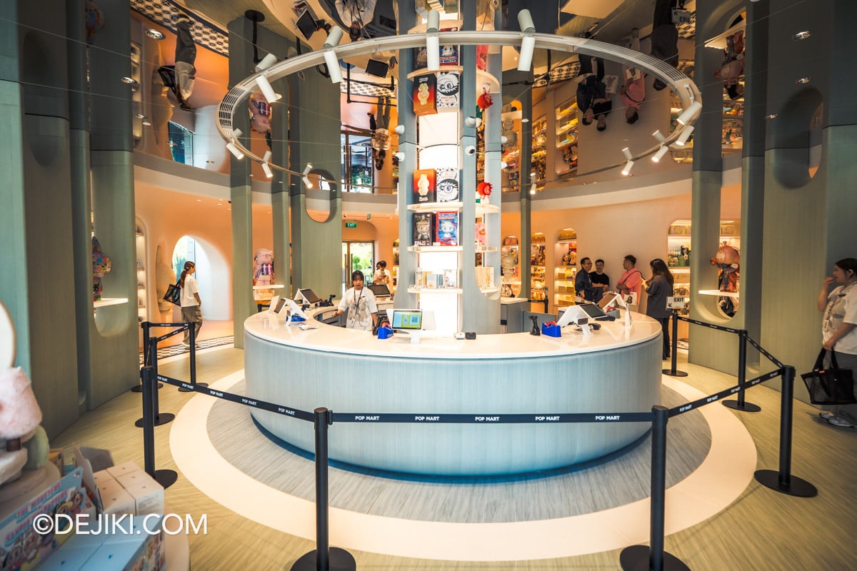 POP MART Resorts World Sentosa - 3 Central Checkout view Circular central checkout counter at POP MART Resorts World Sentosa beneath a mirrored ceiling dome