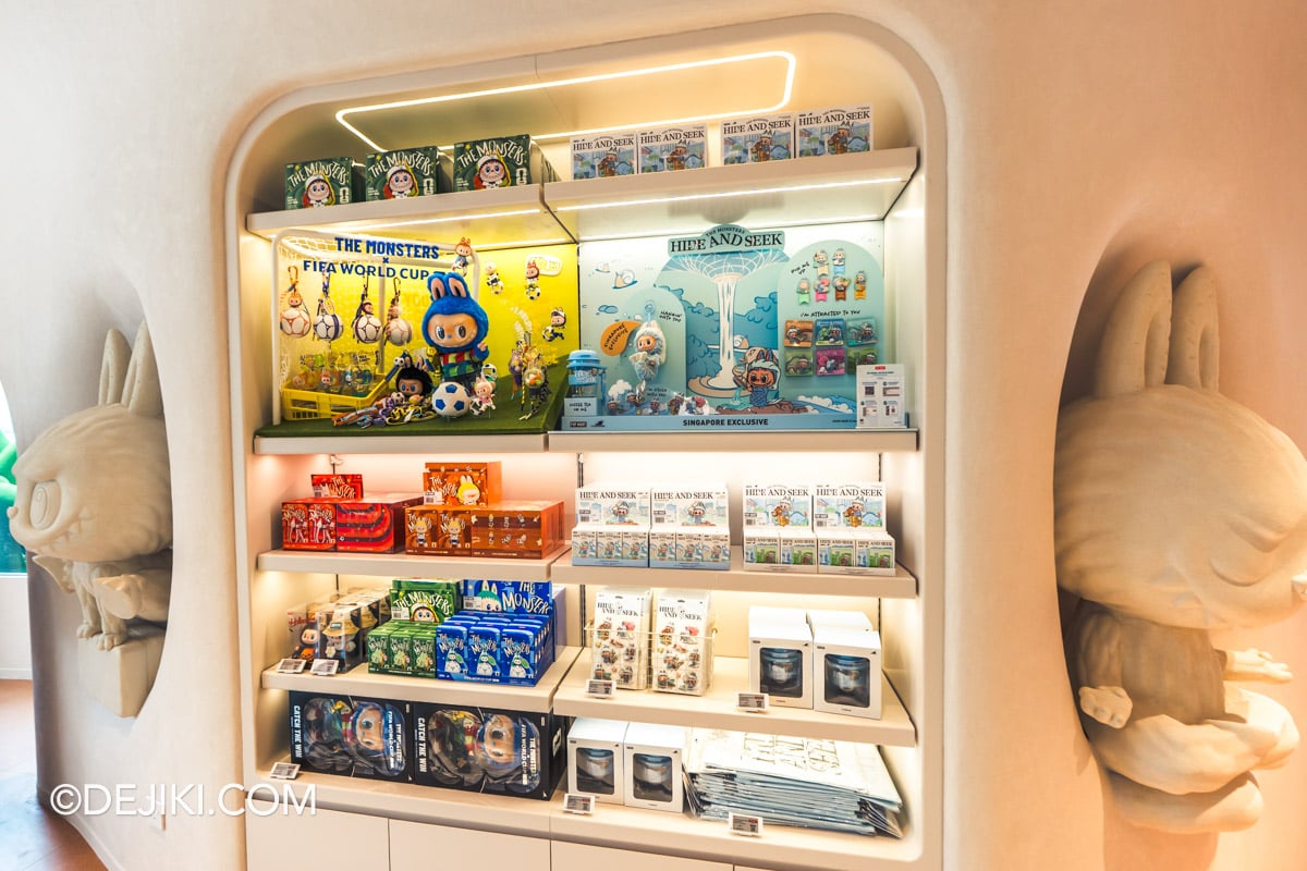 POP MART Resorts World Sentosa - 5 Labubu collections between two Yoga sculptures such as World Cup and Merlion series LABUBU World Cup and Singapore MERLION collections shelved between two stone LABUBU Yoga sculptures at POP MART Resorts World Sentosa